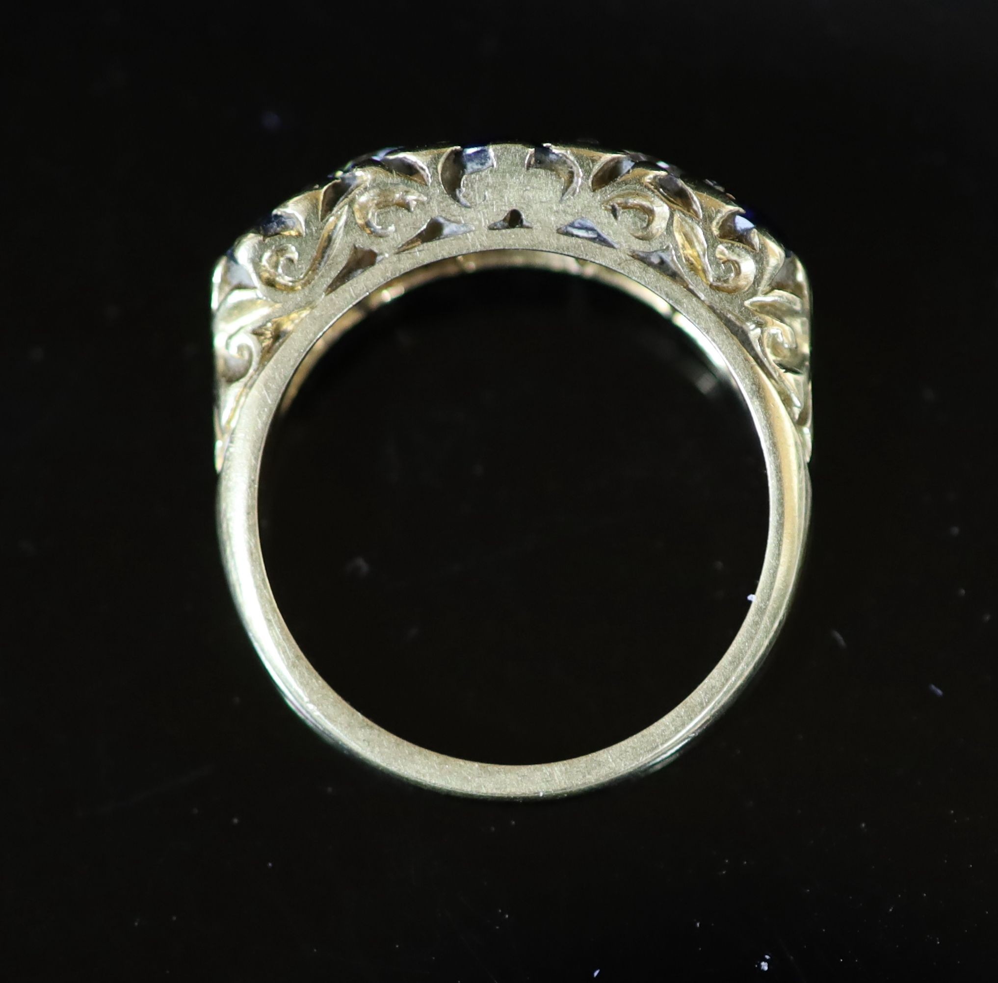 An early 20th century three stone sapphire and two stone diamond set half hoop ring
